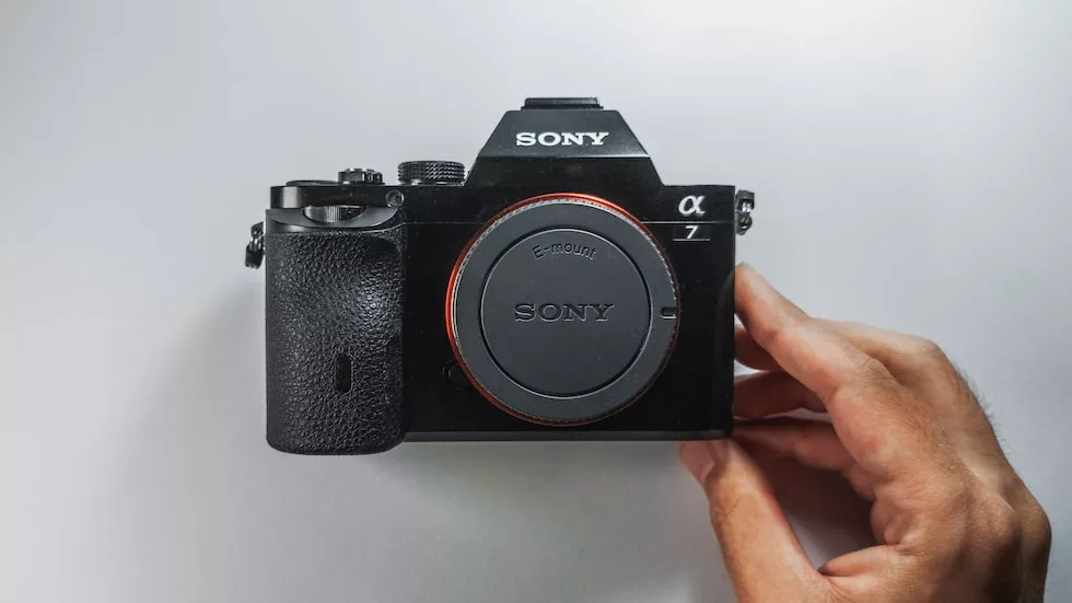 The Sony A7 mirrorless camera sitting on a table with no lens attached.
